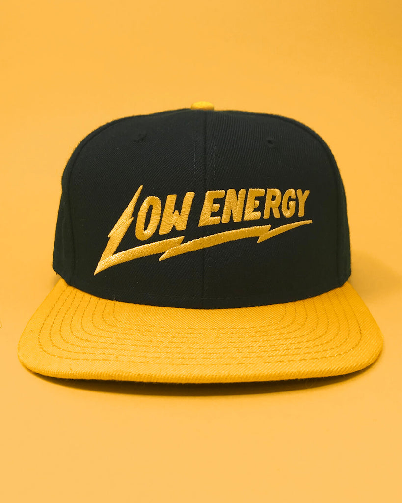 The Low Energy snapback hat in yellow and black.